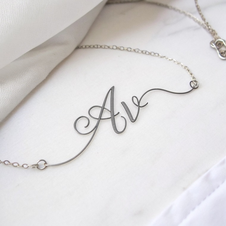 monogram “AV” interlocked, single continuous line, ink on white